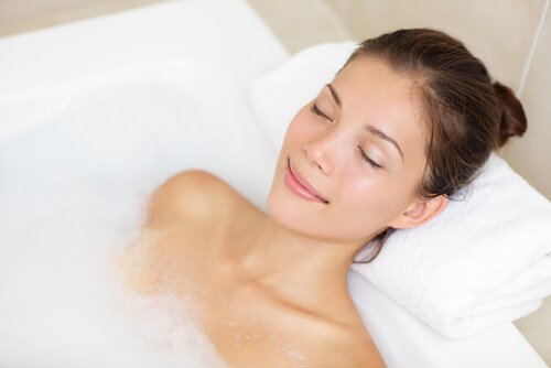 Woman taking a relaxing to get rid of headaches