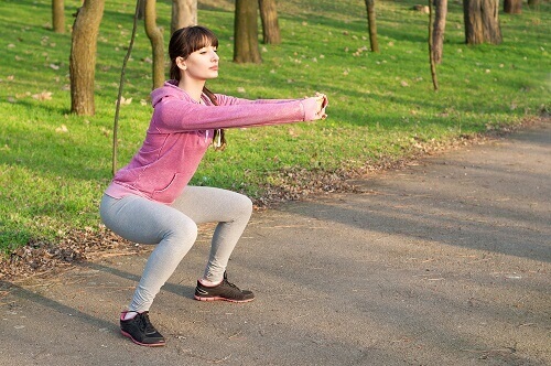 a woman doing squats for firmer buttocks