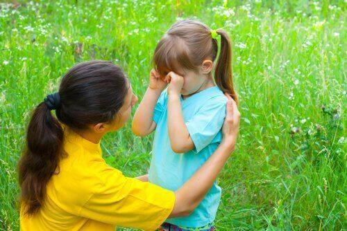 A mother consoling her daughter.
