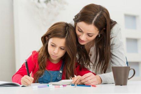A mother helping her daughter with her homework.