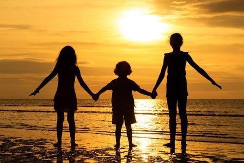 Siblings holding hands.