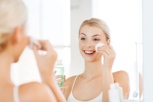 A woman applying a toner.