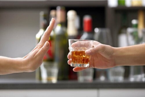 A person declining a drink.