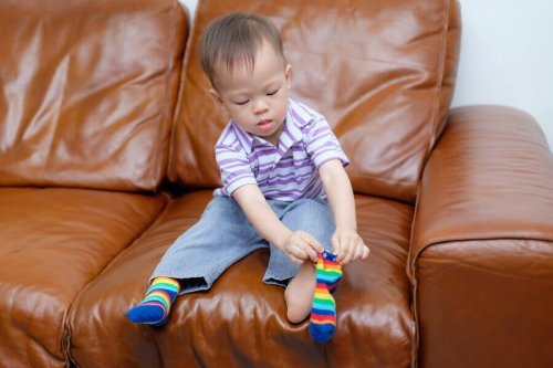 Motor skill development: A toddler putting on socks.