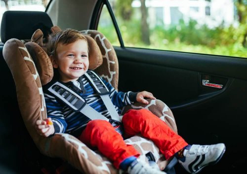 A toddler in a car seat.