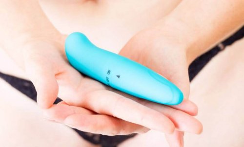 A woman holding a vibrator.