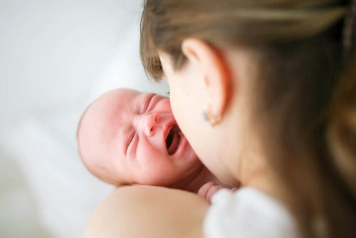 A mother calming a baby that cries non-stop.