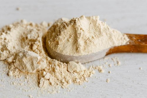 A wooden spoonful of maca powder.
