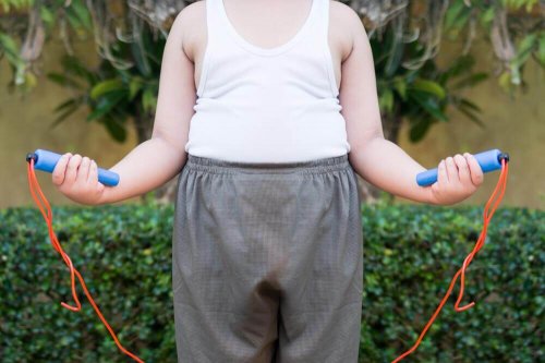 A boy with childhood obesity jumping rope.