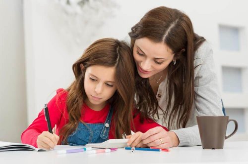 Mother helping her daughter do her homework.