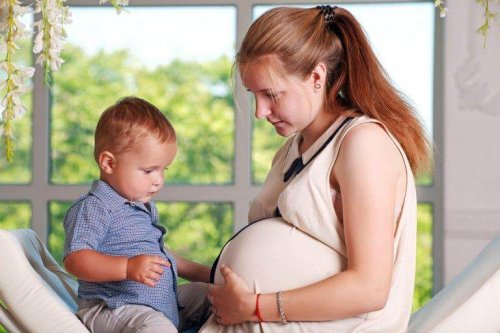 A pregnant woman with her firstborn.