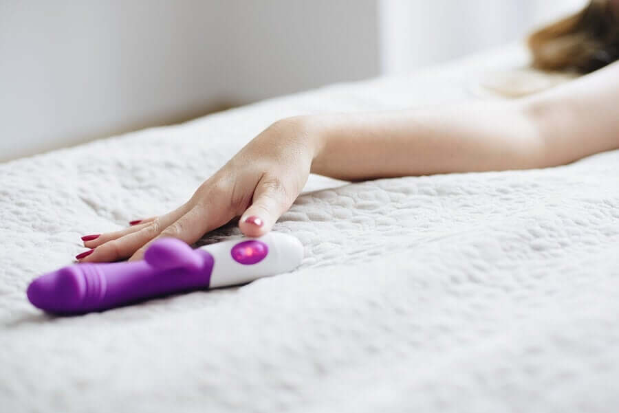 A woman reaching for a dildo.