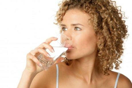 A woman drinking water.