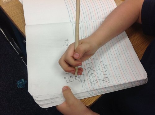 A child practicing spelling.