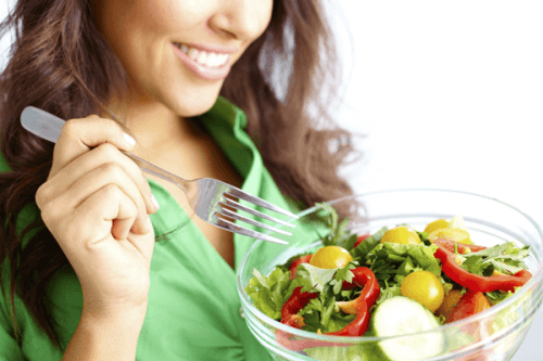 A woman eating a salad.