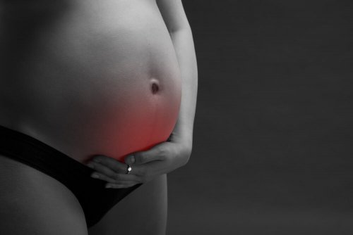 Pregnant woman touching her belly