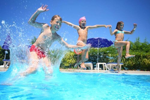 Three children jumping in a pool, they don't seem to be overloaded with activities.