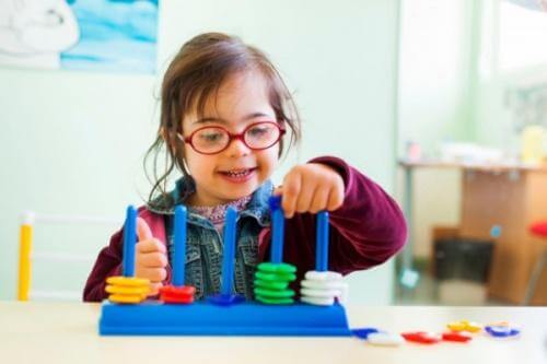 A child with Down syndrome playing.
