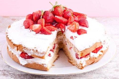 Strawberry cake on a serving dish.