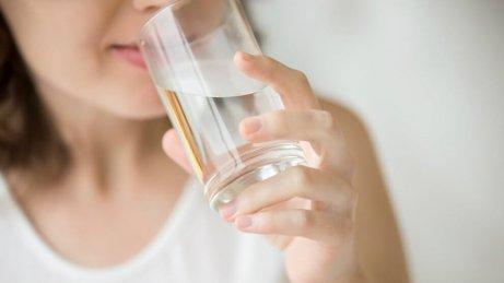 A woman drinking water.