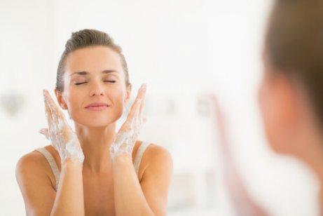 A woman washing her face.