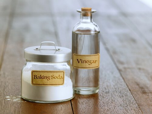 Oven trays: A jar of baking soda and a bottle of vinegar.