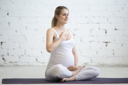 A pregnant woman doing yoga.