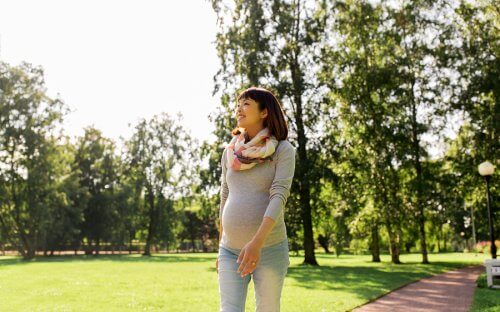 A pregnant woman walking.