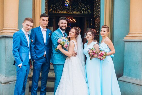A wedded couple with their best men and maids of honor.