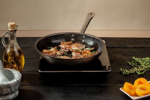 Red partridge with wine in a pan