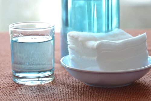 A display of hydrogen peroxide and a bowl with towels.