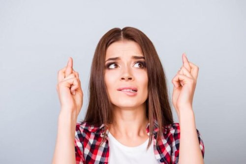 Woman crossing fingers worried about outcome horseshoes are good luck charms