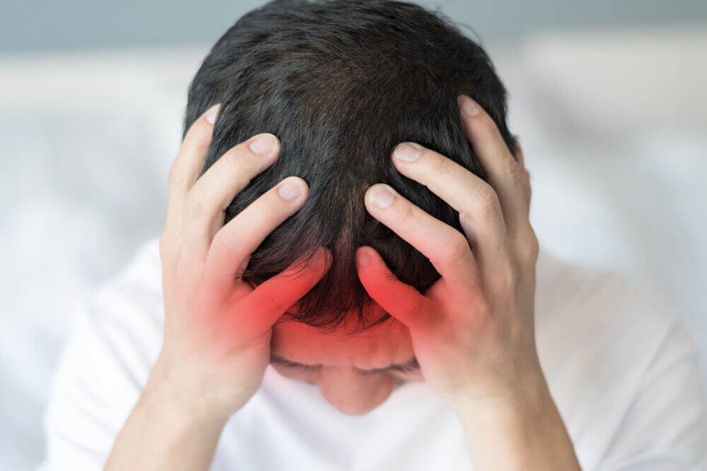 A man with a headache.
