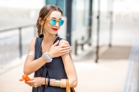 A woman applying sunscreen.