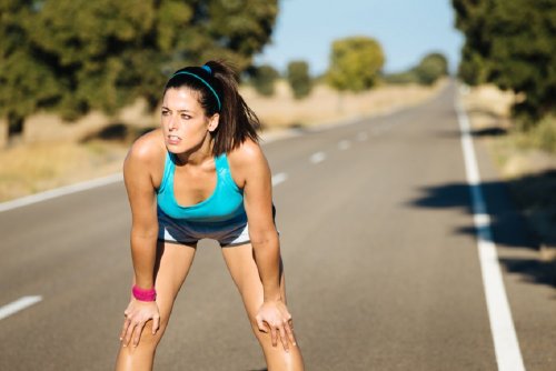 A woman taking a break from jogging.