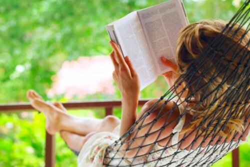 A woman reading in a hammock.