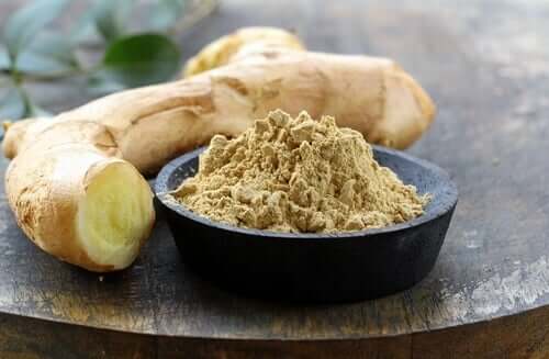 A bowl of ginger powder and root.