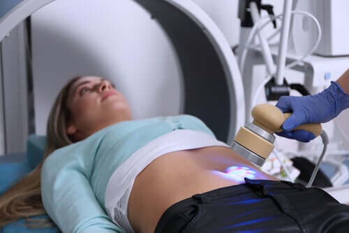 A lab technician doing an ultrasound on a woman.