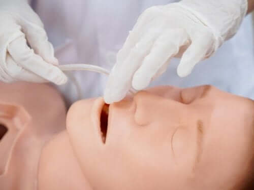 A person practicing nasal intubation.