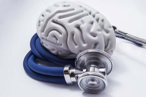A plastic brain wrapped by a stethoscope.