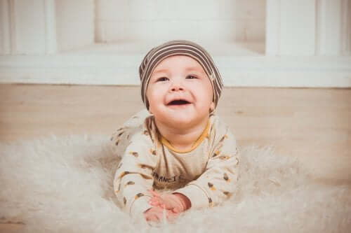 A smiley baby on a rug.