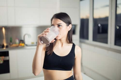 A woman drinking a vegan shake.