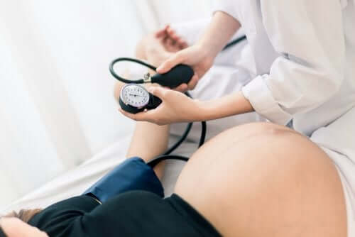 Measuring a pregnant woman's blood pressure.