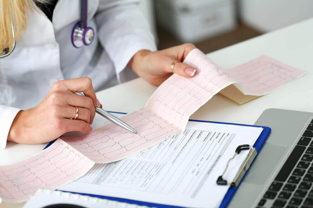 A doctor evaluating the results of an EKG.