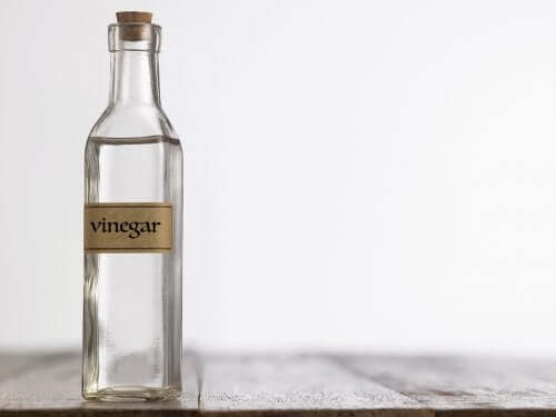 A glass bottle of white vinegar.
