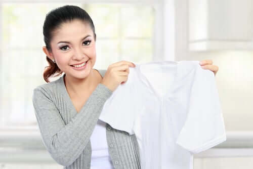 A woman removing stains from a white shirt.