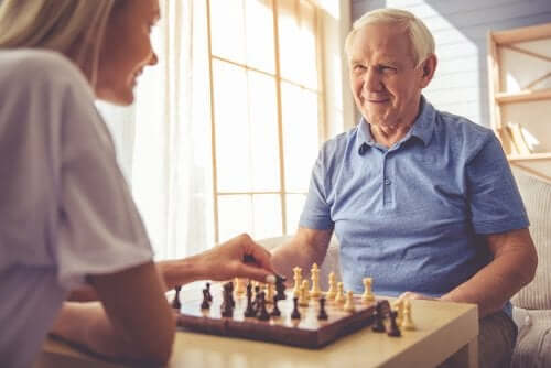 A woman and a man playing chess.