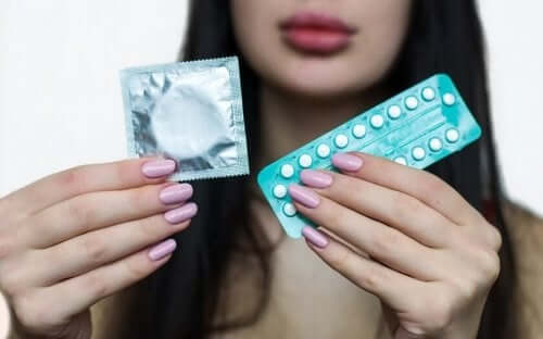 A woman holding contraceptive methods.