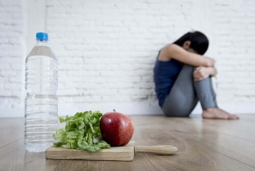Depressed woman with water and food: factors that affect depression