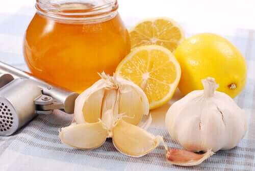 A jar of honey, limes and garlic.